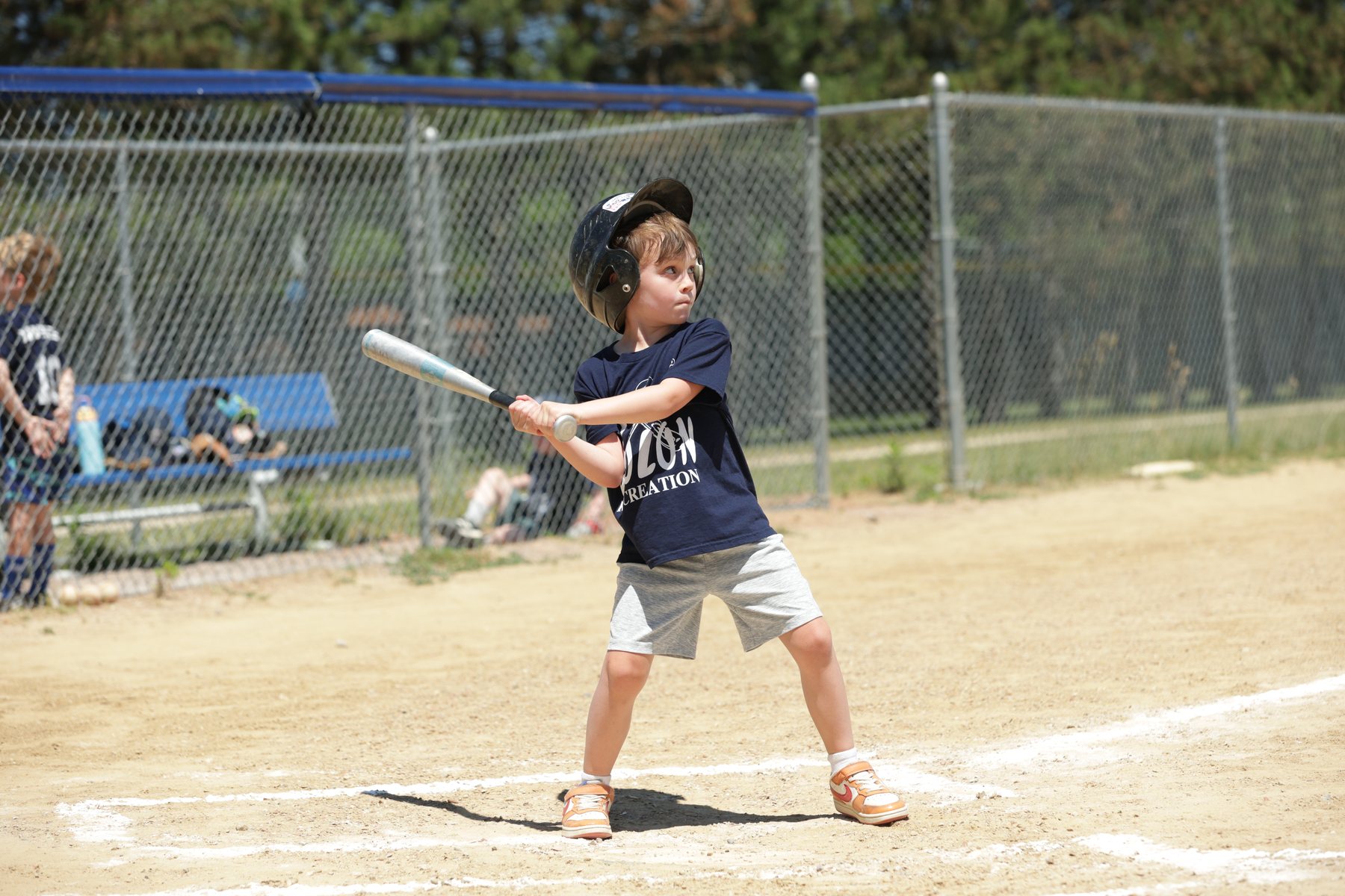 Youth baseball player at bat during a summer game.